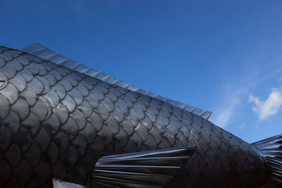 Low angle view of building roof against sky