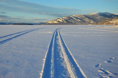 High angle view of tire track on snow covered field