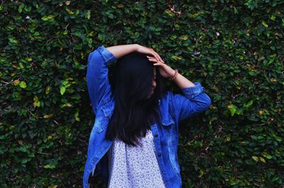 Midsection of woman standing by plants