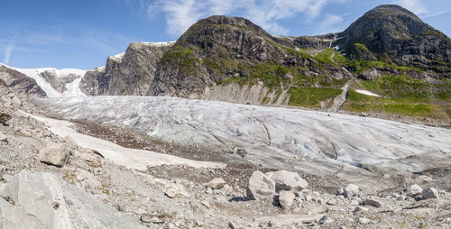 Scenic view of rocky landscape and mountain against sky