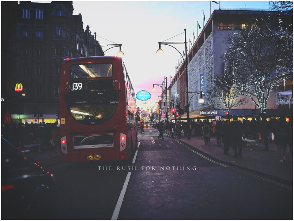 PEOPLE ON STREET IN CITY AGAINST SKY