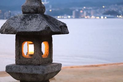 Close-up of illuminated lighting equipment on beach