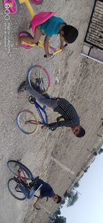 High angle view of boy riding bicycle