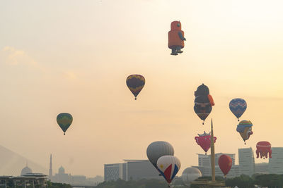 Hot air balloons flying in sky during sunset