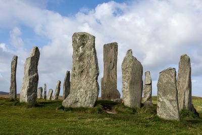 Panoramic view of rocks on field against sky