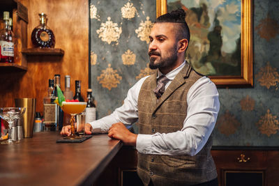 Midsection of man standing in restaurant