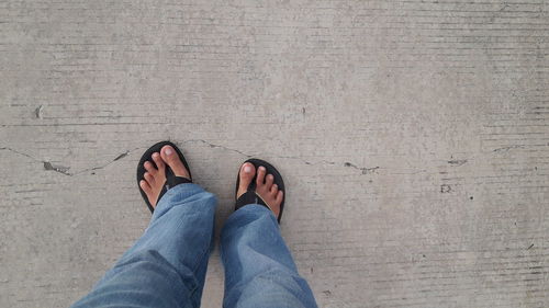 Low section of man standing on ground