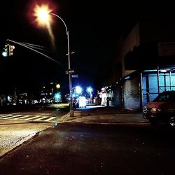 Illuminated empty road at night