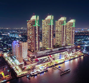 High angle view of illuminated modern buildings in city at night