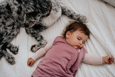 High angle view of cute baby boy sleeping on bed at home