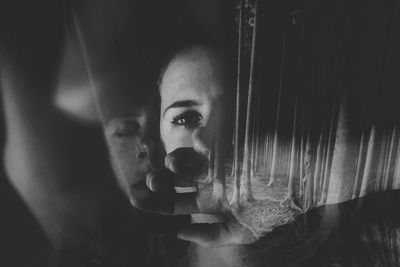 Double exposure of woman and trees in forest