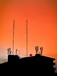 Low angle view of silhouette building against sky during sunset