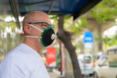 Portrait of man wearing mask in city