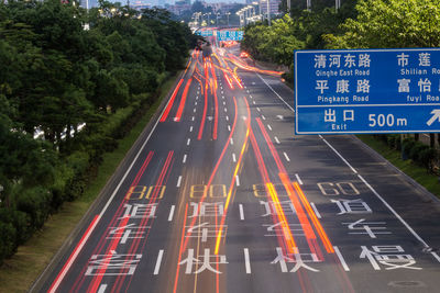 High angle view of light trails on road at night