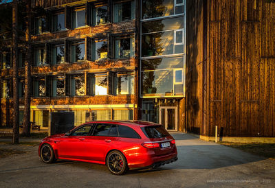 Car on road against buildings at night