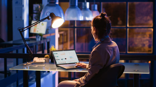 Man using laptop at cafe