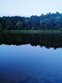 Scenic view of lake against blue sky