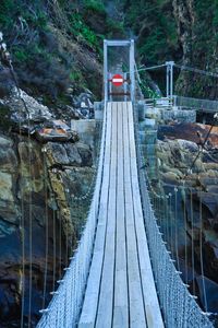 Suspension bridge at storm river mouth, south africa with no through traffic sign