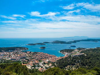 High angle view of townscape by sea against sky