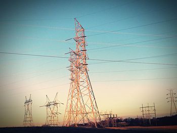 Low angle view of electricity pylon against sky