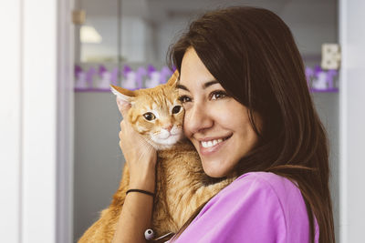 Portrait of smiling woman with cat