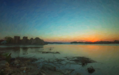 Scenic view of lake against sky during sunset