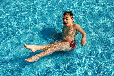 Boy swimming in pool