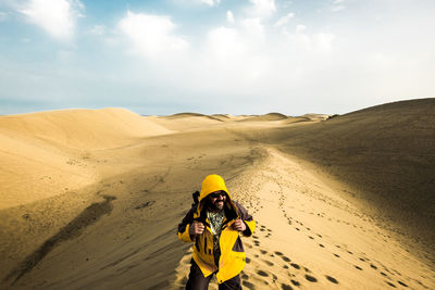 Portrait of young woman on sand