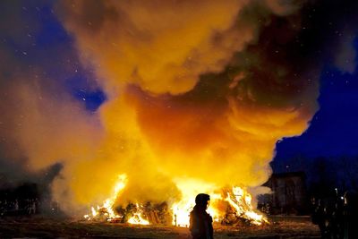 Silhouette of man with fire crackers at night