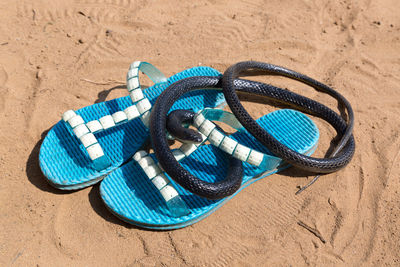 High angle view of shoes on sand at beach