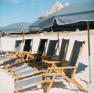 Side view of sun loungers at beach