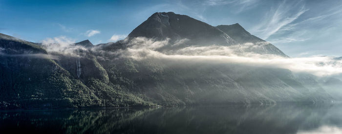 Scenic view of lake and mountains against sky