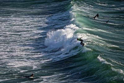 High angle view of people surfing on sea