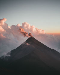 Scenic view of volcanic mountain against sky during sunset