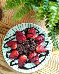 Chocolate sauce on strawberries on plate