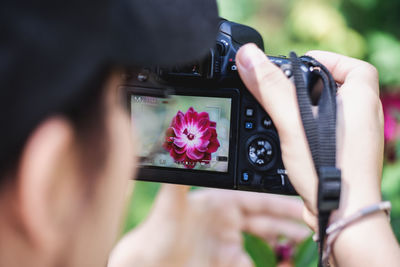 Midsection of woman photographing with camera