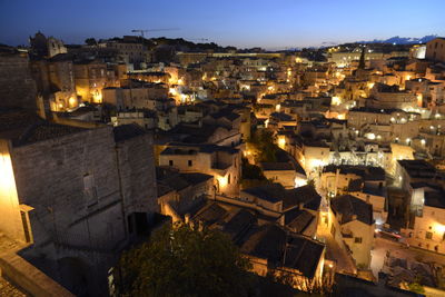 High angle view of illuminated buildings in city at night