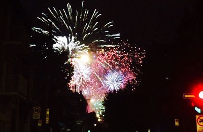 Low angle view of firework display at night
