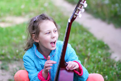 Portrait of a smiling girl holding outdoors