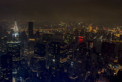 Illuminated cityscape against sky at night