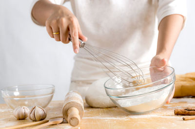 Midsection of man preparing food in kitchen