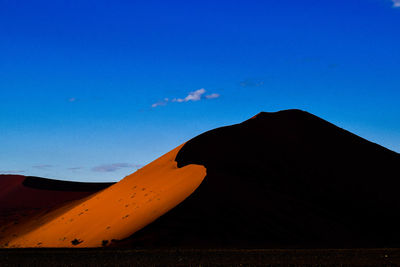 View of desert against blue sky