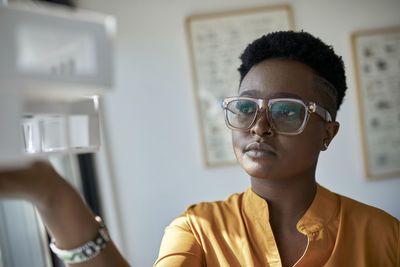 Portrait of boy wearing eyeglasses at home