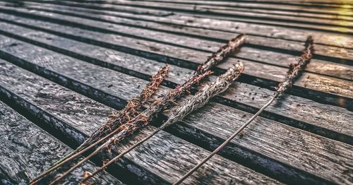 High angle view of rusty metal on boardwalk