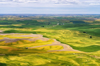 Scenic view of agricultural field against sky