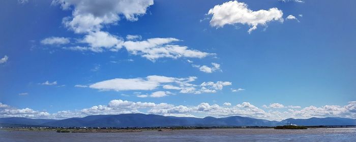 Scenic view of sea and mountains against sky