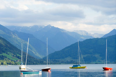 Sailboats in sea against sky
