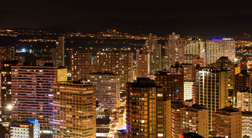 Aerial view of city lit up at night