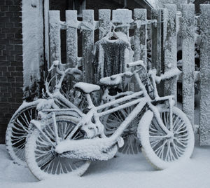 Close-up of snow covered bicycle