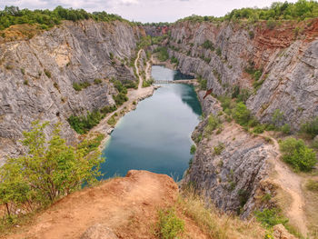 Blue lagoon at the bottom of area amerika canyon, czech republic. wild nature in a stone canyon